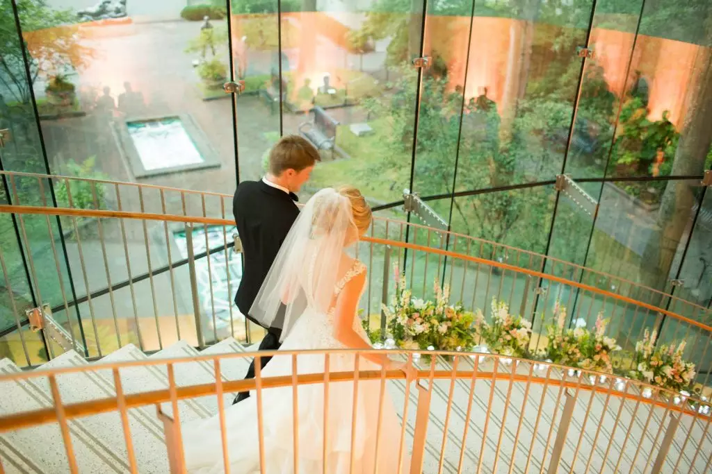 bride and groom walking down staircase birmingham museum of art