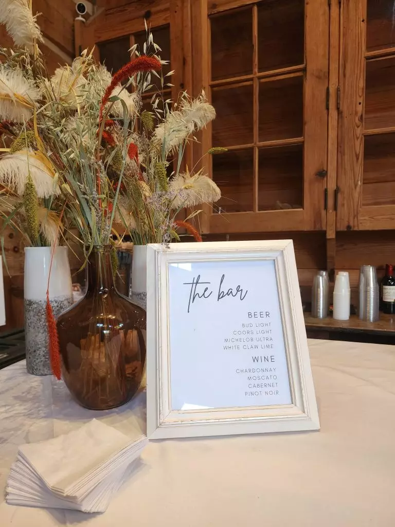 bar menu and floral arrangement inside at swan lake stables