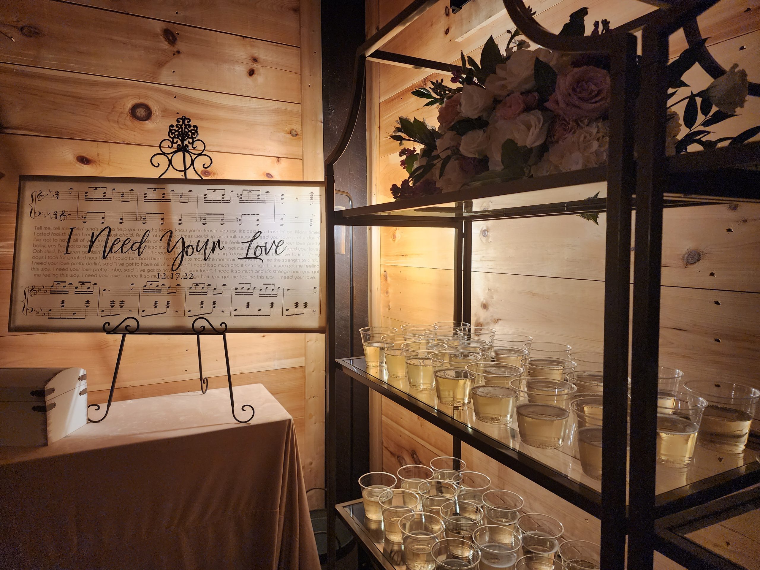gold shelves with bnb beverage management champagne and wedding welcome sign