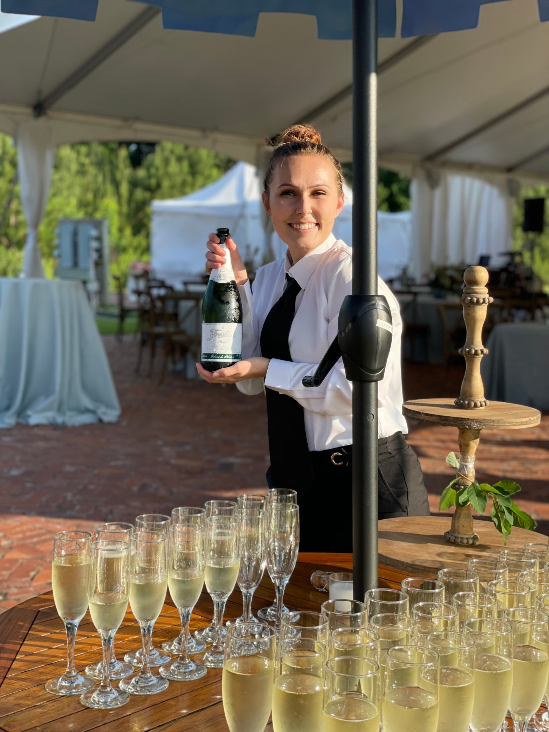 BNB Beverage Management bartender serving champagne at wedding at parker hill