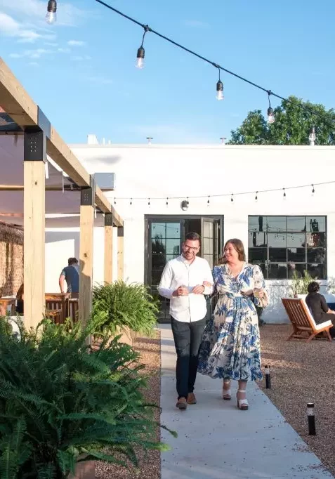 couple walking outside avenue d rooftop