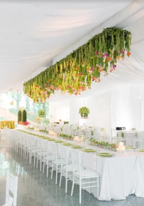 white classy table with floral arrangements and hanging florals at birmingham museum of art