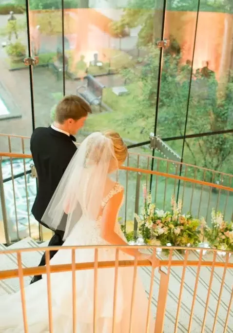 bride and groom walking down staircase birmingham museum of art