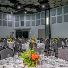 tables with floral arrangements set up cook museum event space