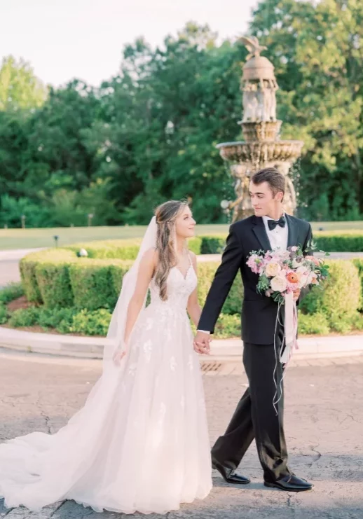 Bride and Groom walking holding hands at auburn wedding venue