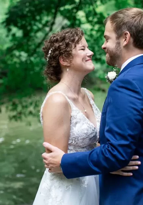 bride and groom in blue tuxedo outside photoshoot