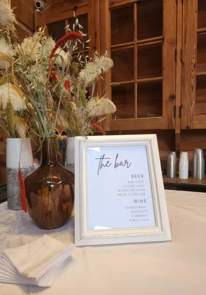 bar menu and floral arrangement inside at swan lake stables